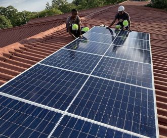 Installing solar panels in Mazowe High School